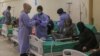 Health workers attend to suspected cholera patients inside a field hospital in Bebnine, Akkar district, northern Lebanon, Oct. 28, 2022. 