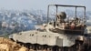 Israeli army soldiers are seen on an armed vehicle during a military operation around Al-Shifa hospital in Gaza City, Nov. 15, 2023, amid continuing battles between Israel and the Palestinian militant group Hamas. (Israel Defense Forces via AFP) 