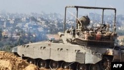 Israeli army soldiers are seen on an armed vehicle during a military operation around Al-Shifa hospital in Gaza City, Nov. 15, 2023, amid continuing battles between Israel and the Palestinian militant group Hamas. (Israel Defense Forces via AFP) 