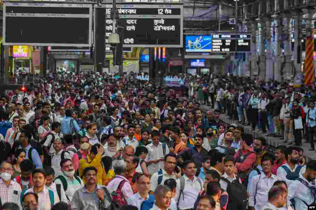 People wait for their train on platforms at the Chhatrapati Shivaji Terminus (CST) railway station Mumbai, India. India is set to overtake China as the world's most populous country by the end of June, U.N. estimates showed.