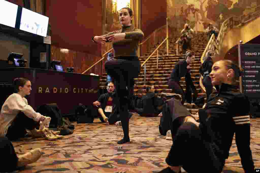 Dancers stretch ahead of auditions for a spot on the Rockettes line for the "2023 Christmas Spectacular Starring the Radio City Rockettes" at Radio City Music Hall in New York.