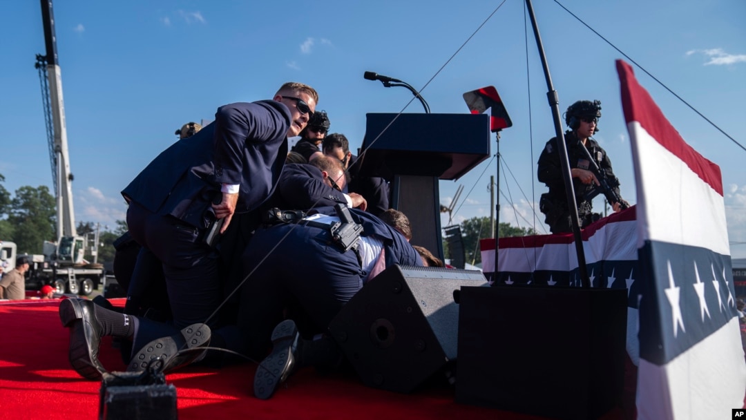FILE - Republican presidential candidate former President Donald Trump is shielded by U.S. Secret Service agents during a shooting at a campaign rally in Butler, Pennsylvania, July 13, 2024.