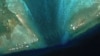 Satellite Images Reveal Floating Barrier at Mouth of Disputed Atoll in South China Sea 