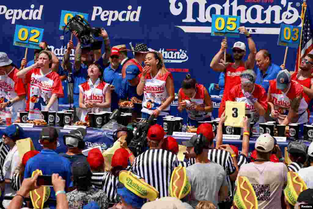People compete in the 2023 Nathan's Famous Fourth of July International Hot Dog Eating Contest at Coney Island in New York City.