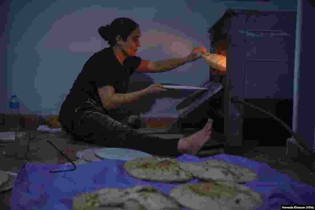 Omu Abanoub makes bread. “The subsidized bakeries usually shut down early in the day, so we aren’t able to get our loaves every day,” the mother says, since she works two low-paying jobs and her children are in school. Cairo, Egypt, June 25, 2024. (Hamada Elrasam/VOA)