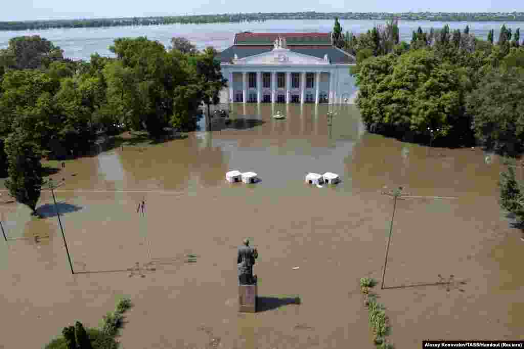 A view shows the House of Culture on a flooded street in Nova Kakhovka after the nearby dam was breached in the Kherson Region, Russian-controlled Ukraine. Ukraine and Russia accused each other of blowing up the Kakhovka dam, setting off a new crisis in the war-torn country.