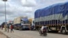 Trucks carrying goods are stranded at the border between Nigeria and Niger in Jibia, Nigeria, on Aug. 7, 2023. The West Africa regional bloc's decision to shut borders with Niger in sanctioning the country's coup plotters is affecting Nigerian towns.