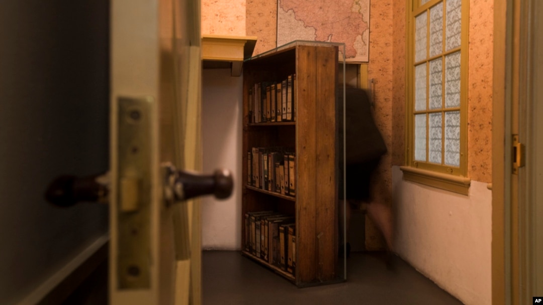 FILE - A woman enters the secret annex at the renovated Anne Frank House Museum in Amsterdam, Netherlands, Nov. 21, 2018.