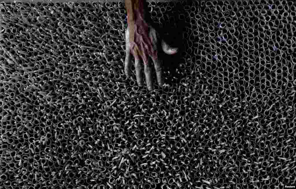 A man works at a firecracker factory ahead of Sinhala and Tamil New Year festival, in Kimbulapitiya, Sri Lanka.