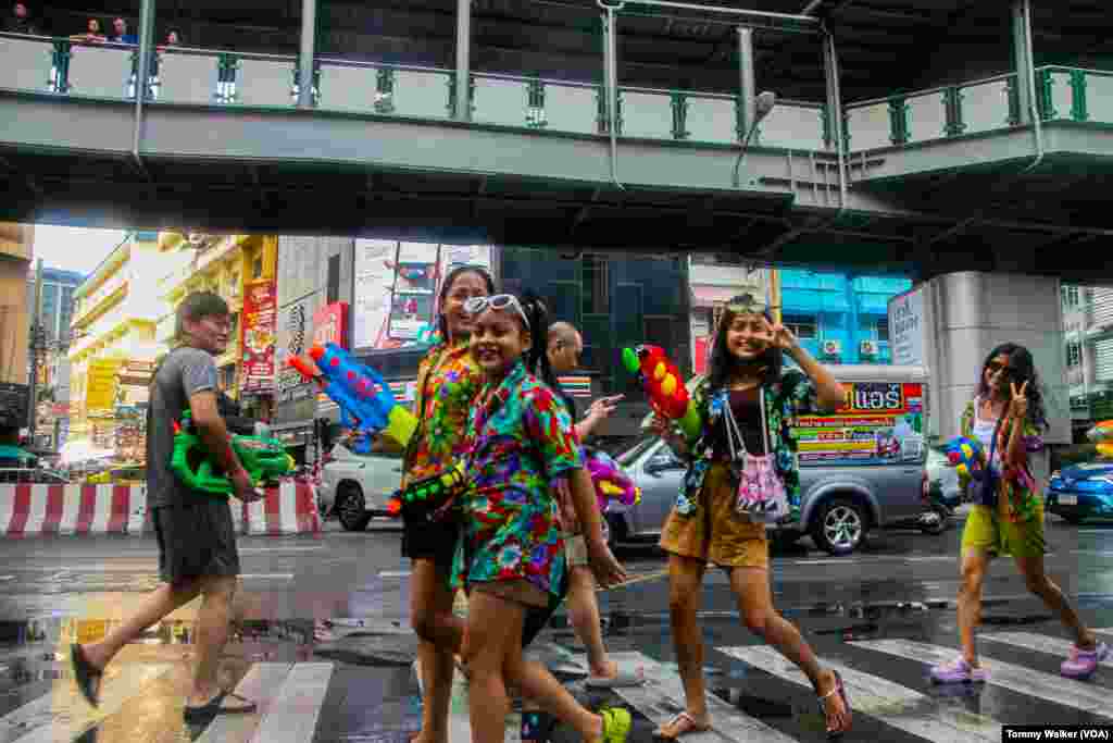 Thais use toy water guns to douse others with water as a cleansing ritual for Songkran, Bangkok, April 13, 2024.