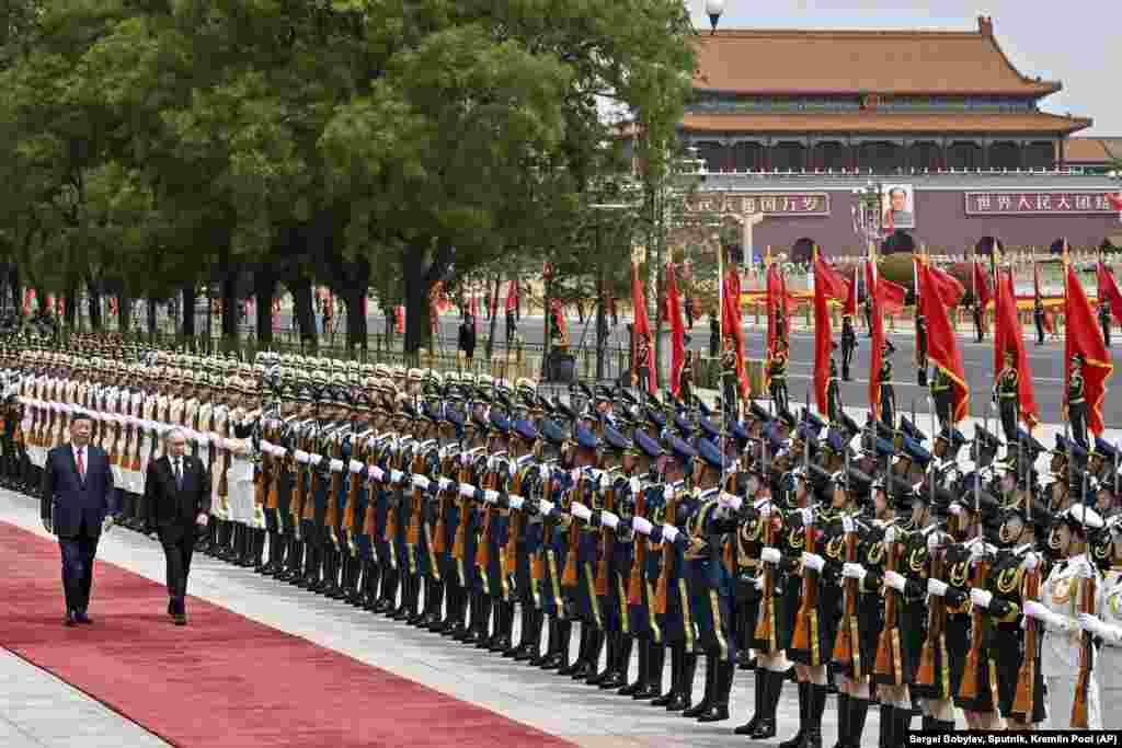Chinese President Xi Jinping, left, and Russian President Vladimir Putin review the honor guard during an official welcome ceremony in Beijing.