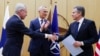 Finnish Foreign Minister Pekka Haavisto, left, shakes hands with United States Secretary of State Antony Blinken, right, during a meeting of NATO foreign ministers at NATO headquarters in Brussels, Tuesday, April 4, 2023. (Johanna Geron, Pool Photo via AP)