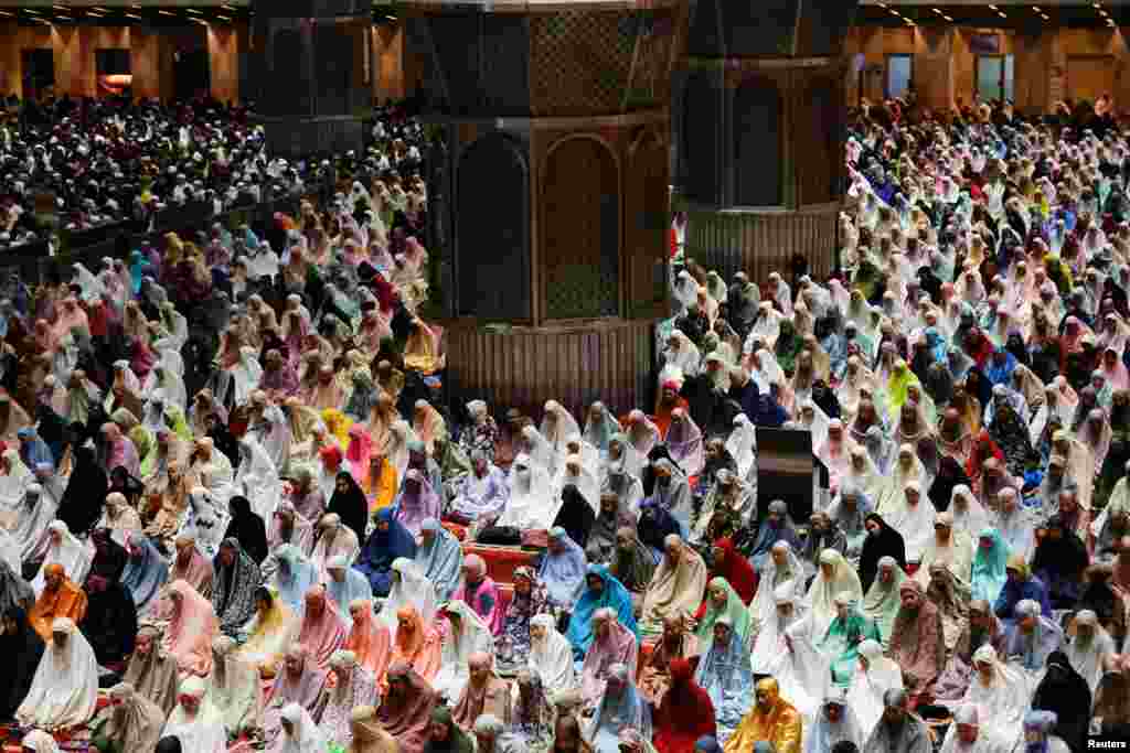 Muslim women attend mass prayers known as 'Tarawih' during the first eve of the holy fasting month of Ramadan, at the Great Mosque of Istiqlal in Jakarta, Indonesia.