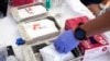 FILE - Syringes with vaccines are prepared at the L.A. Care and Blue Shield of California Promise Health Plans' Community Resource Center where they were offering members and the public free flu and COVID-19 vaccines Oct. 28, 2022, in Lynwood, Calif. 