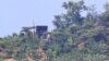 11일 북한 확성기로 추정되는 시설이 남북간 비무장지대(DMZ) 인근 강화도에서 바라본 북한 언덕 꼭대기에 보인다.