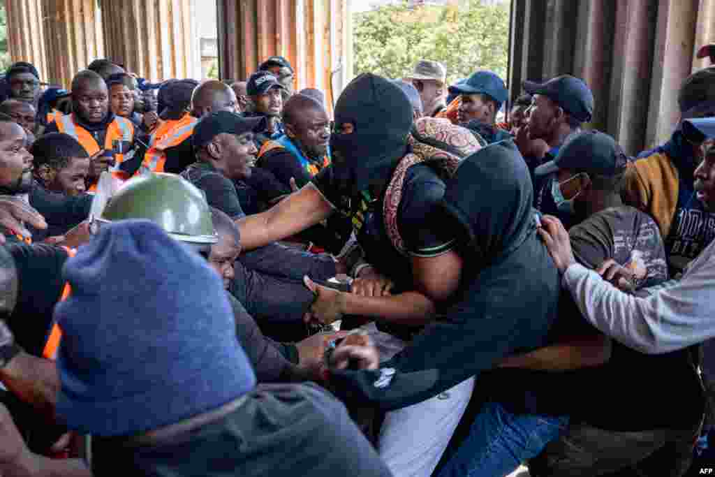 University security and demonstrating students clash as they attempt to gain entry to the Great Hall at the University of the Witwatersrand (WITS) in Johannesburg, South Africa. The students were protesting what they allege is a lack of adequate support from the university for unhoused students and those with outstanding fees. 