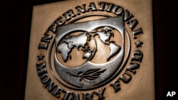 FILE - The logo of the International Monetary Fund is visible on its building in Washington, April 5, 2021. An IMF delegation began reviewing Pakistan’s current loan program on March 14, 2024.