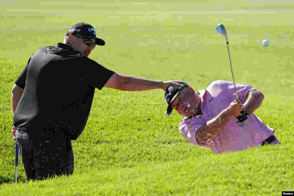 Owen Robinson from England is guided by Deon Maritz from South Africa on the practice green, ahead of the 2023 World Blind Golf Championships at Milnerton Golf Club in Cape Town, South Africa.