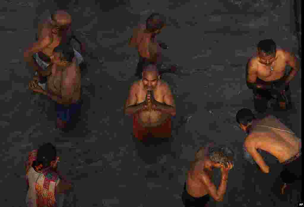 Devotees take holy dips and pray in the river Saryu on the occasion of Ramnavi festival, celebrated as the birthday of Hindu God Rama, in Ayodhya, India.