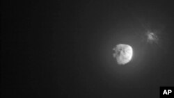 FILE - Debris ejects from the asteroid Dimorphos, right, a few minutes after the intentional collision of NASA’s Double Asteroid Redirection Test mission on Sept. 26, 2022, captured by the nearby Italian Space Agency’s LICIACube. (NASA)