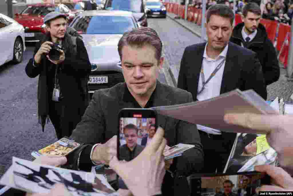 Matt Damon signs autographs upon arrival for the photo call for the film 'Kiss The Future' during the International Film Festival 'Berlinale', in Berlin, Germany.