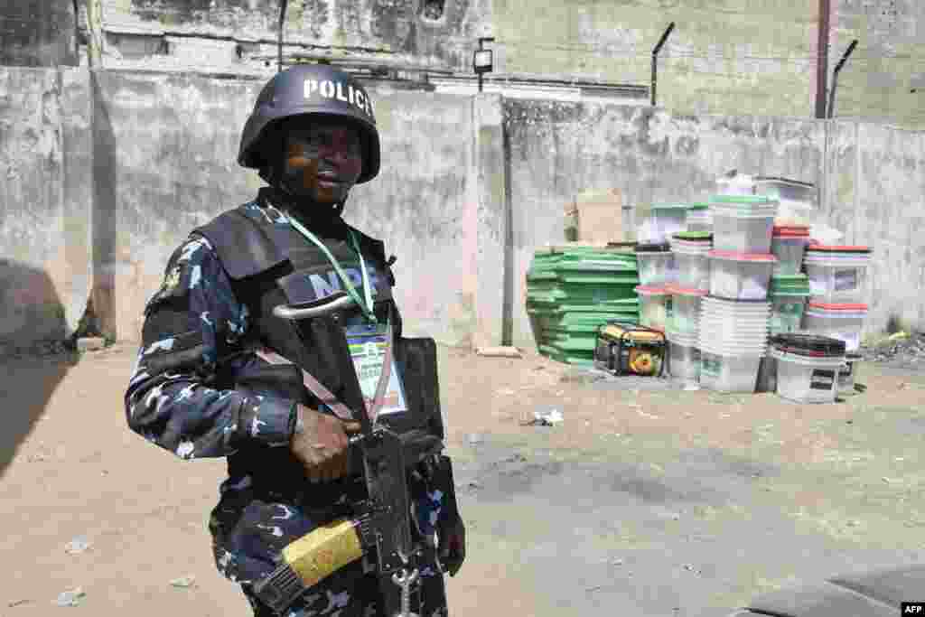 An anti-riot police officer is seen at the state headquarters of Independent National Electoral Commission in Yola, the day after Nigeria's presidential and general election.