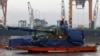FILE - A worker uncovers South Korean Thunder K9 howitzer in the Polish Navy port of Gdynia, Poland, Dec. 6, 2022. A leaked US memo allegedly describes discussions within South Korea’s presidential office about whether to provide weapons to Ukraine.
