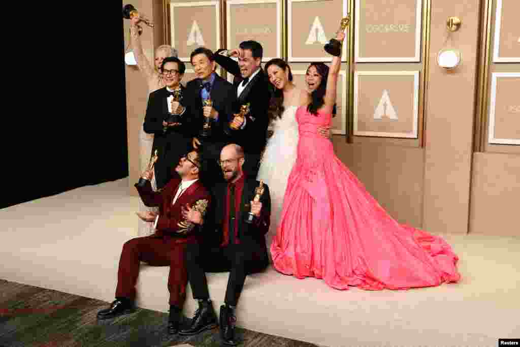 Daniel Kwan, Daniel Scheinert, Jonathan Wang and the cast pose with the Oscar for Best Picture for "Everything Everywhere All at Once" at the 95th Academy Awards in Los Angeles, March 12, 2023.