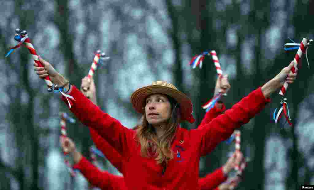 Members of Hexhamshire Lasses perform at sunrise to traditionally mark May Day in Henshaw, Northumberland, Britain.