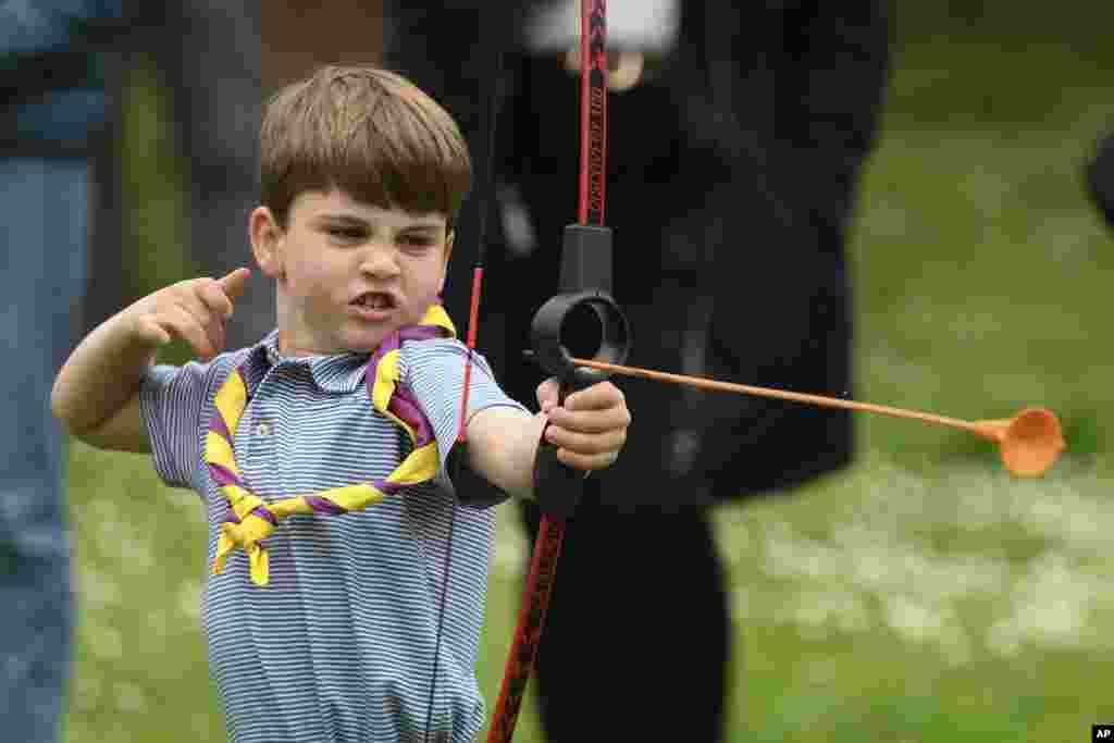 Britain's Prince Louis tries his hand at archery while taking part in the Big Help Out, during a visit to the 3rd Upton Scouts Hut in Slough, England.