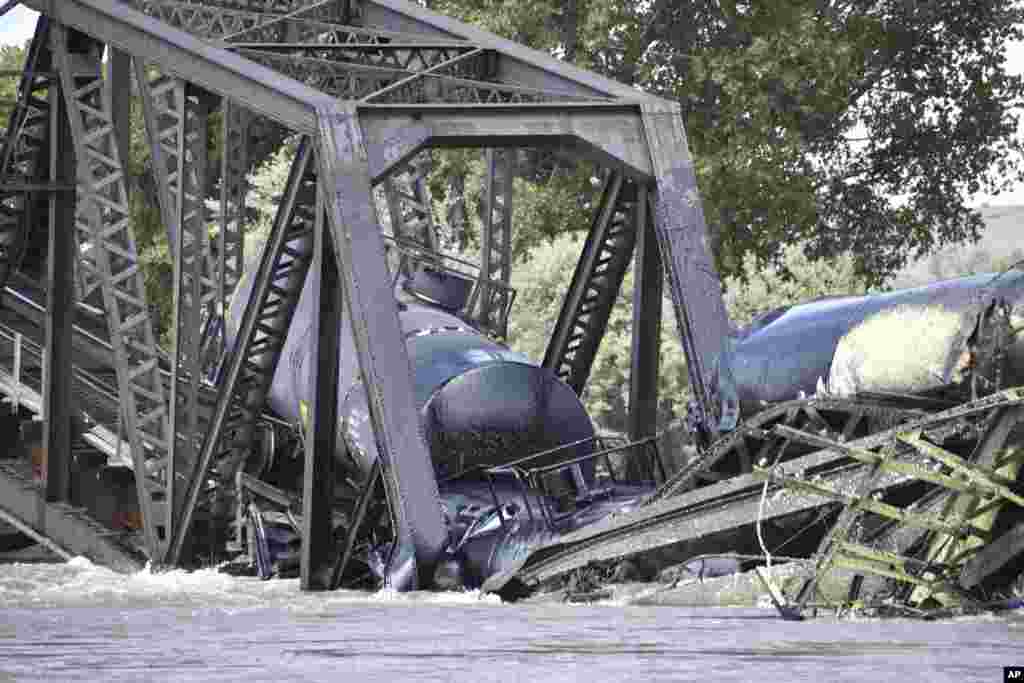 Several train cars are immersed in the Yellowstone River after a bridge collapse near Columbus, Montana, June 24, 2023.