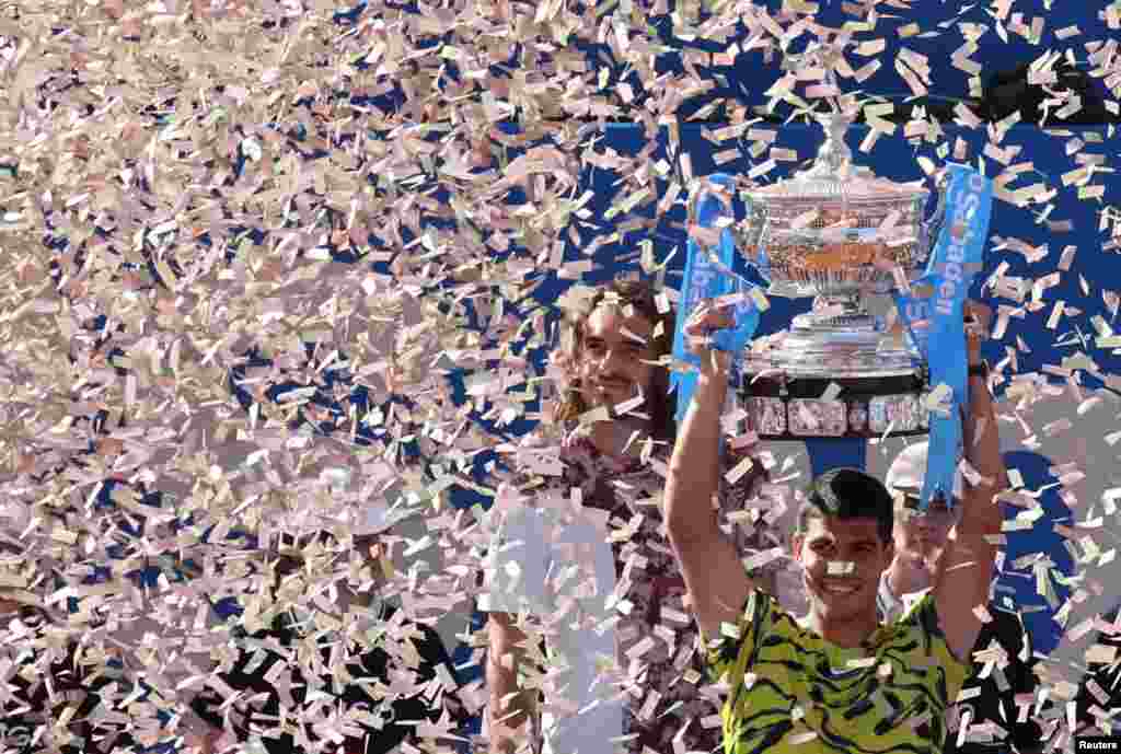 Spain&#39;s Carlos Alcaraz celebrates with the trophy after winning the Barcelona Open in the final match against Greece&#39;s Stefanos Tsitsipas in Barcelona, Spain.