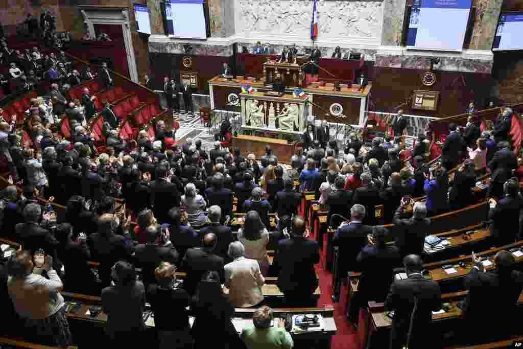 French lawmakers applaud Ukrainian President Volodymyr Zelenskyy at the National Assembly, in Paris.