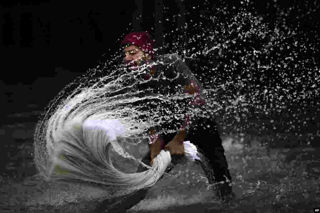 A man washes clothes on the banks of the Brahmaputra River, on World Water Day, in Guwahati, India.