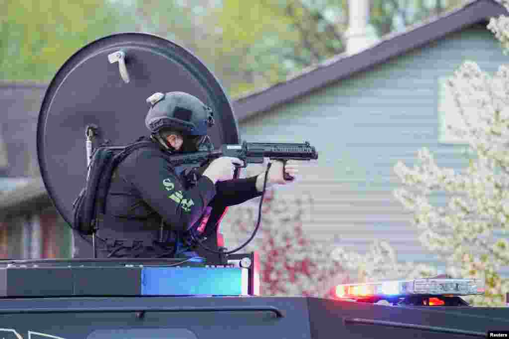 A SWAT officer fires tear gas towards the demonstrators as they attend a protest held after a grand jury voted against indicting police officers in the fatal shooting of unarmed Black man Jayland Walker, in Akron, Ohio, April 19, 2023. 