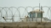 FILE - A watchtower of an alleged detention facility is seen in Artux in Kizilsu Prefecture in China's northwestern Xinjiang region, July 19, 2023.