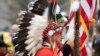 Blas Preciado, the vice commander of the Kiowa Blackleggings Warrior Society, takes part in the dedication of the National Native American Veterans Memorial on Friday, Nov. 11, 2022 in Washington. 