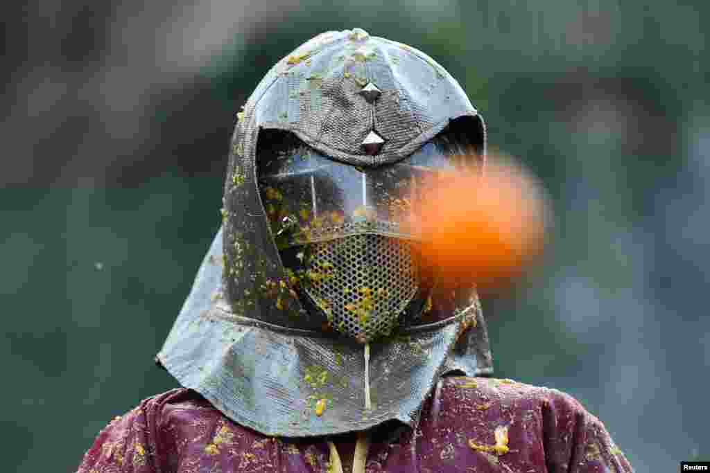 A person participates in the annual 'Battle of the Oranges' in the northern city of Ivrea, Italy.