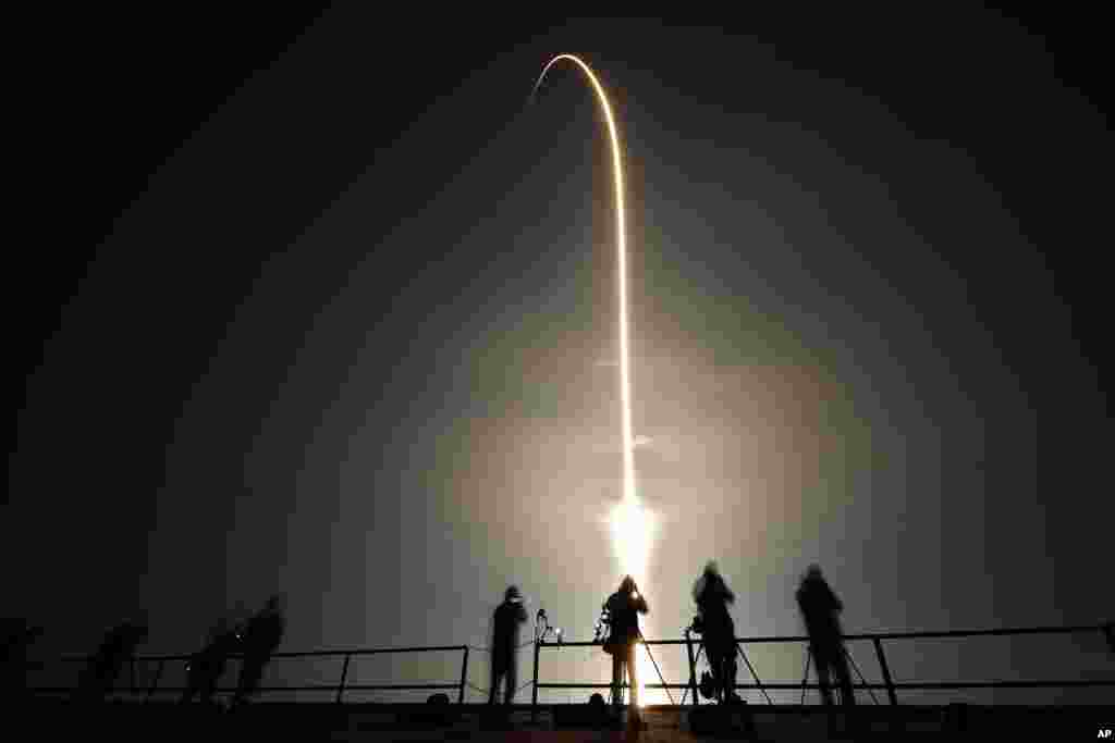 A SpaceX Falcon 9 rocket lifts off in this time exposure photograph from Launch Pad 39-A, at the Kennedy Space Center in Cape Canaveral, Florida.