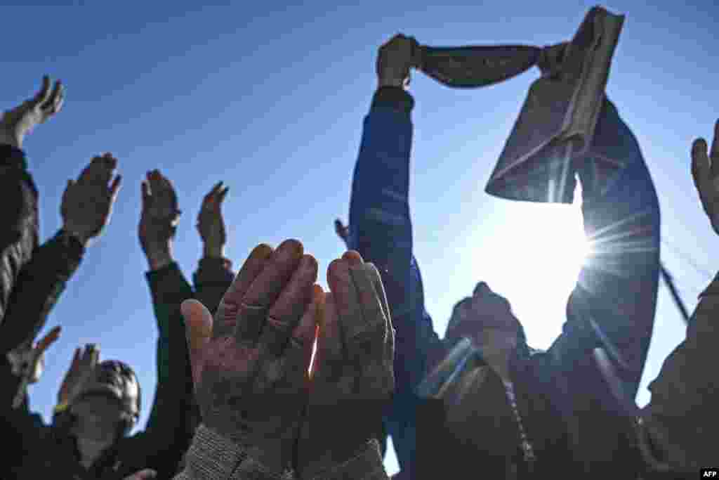 Muslim devotees react as a priest displays a holy relic, believed to be a hair from the Prophet Muhammad's beard, during the last Friday of Miraj-Ul-Alam (ascension to heaven) celebrations at Kashmir's main Hazratbal shrine in Srinagar.