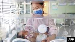 FILE - A medical worker takes care of a newborn baby at a hospital in Lianyungang, in China's eastern Zhejiang province on March 8, 2023. 