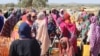 FILE - Refugees fleeing the conflict in Sudan queue with their jerrycans to collect drinking water from the Doctors Without Borders (MSF) distribution point at the Ourang refugee camp in Adre, Chad, on Dec. 7, 2023. 