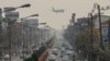 FILE - An airplane flies over a busy road amid high levels of air pollution in Chiang Mai in northern Thailand on March 10, 2023. The long-awaited relaunch of Thailand’s Songkran festival could be overshadowed by the country’s air pollution.
