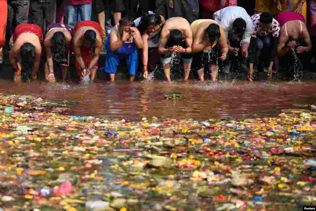 Devotees take a holy bath at Matathirtha to commemorate their departed mothers during Mother's Day in Kathmandu, Nepal.