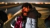 FILE - A couple from Cuba wait to be processed to seek asylum after crossing the border into the United States, Jan. 6, 2023, near Yuma, Ariz.