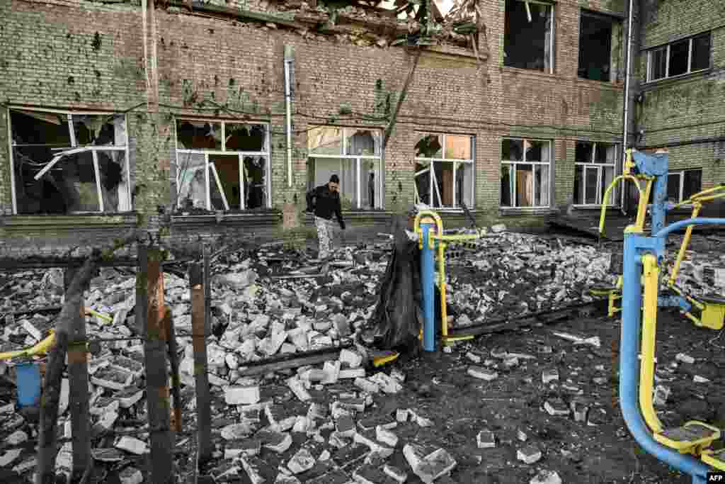 A man walks outside a destroyed school after a missile strike in Kramatorsk, Dombass region, amid Russian invasion of Ukraine.