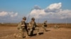 FILE - U.S. soldiers pause during a patrol in Syria, Feb. 3, 2023.
