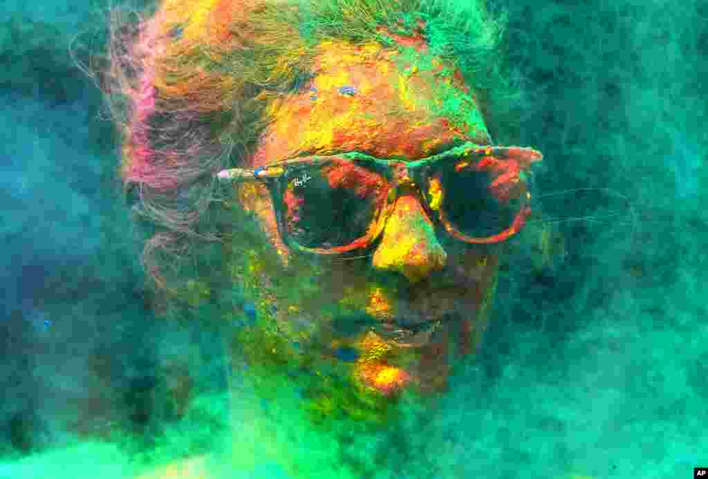 A woman smeared with colors celebrates Holi, the Hindu festival of colors, in Mumbai, India.