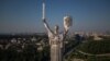 Steeplejacks are installing the coat of arms of Ukraine on the shield of the 102-metre Motherland Monument in Kyiv on August 6, 2023. (Photo by Roman PILIPEY / AFP)