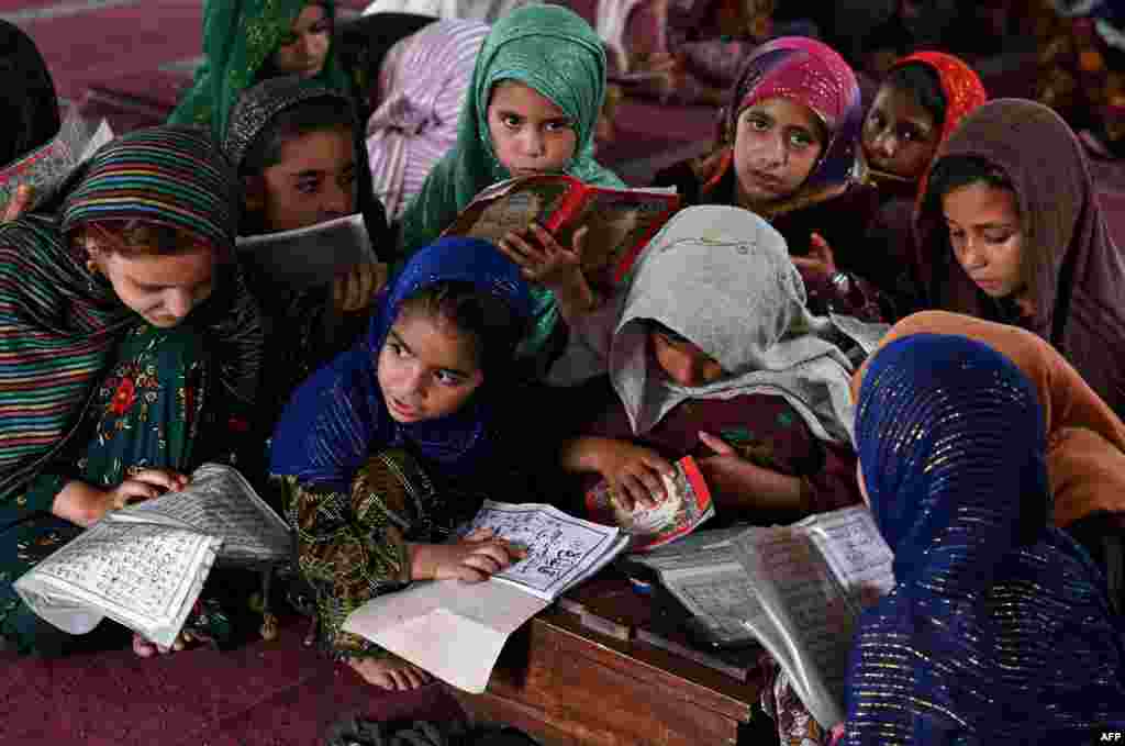 Children recite holy book Quran at a mosque in Lahore, Pakistan.